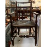 OAK FRAMED ARMCHAIR WITH RUSH SEAT & TURNED SUPPORTS