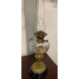 BRASS OIL LAMP ON EBONISED BASE