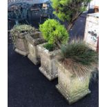 4 MATCHING WEATHERED RECONSTITUTED STONE SQUARE PLANTERS EACH WITH FLOWER CARVED DECORATION