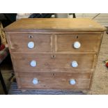 A VICTORIAN PINE CHEST OF DRAWERS, 2 SHORT & 2 LONG ON BUN FEET WITH CERAMIC HANDLES