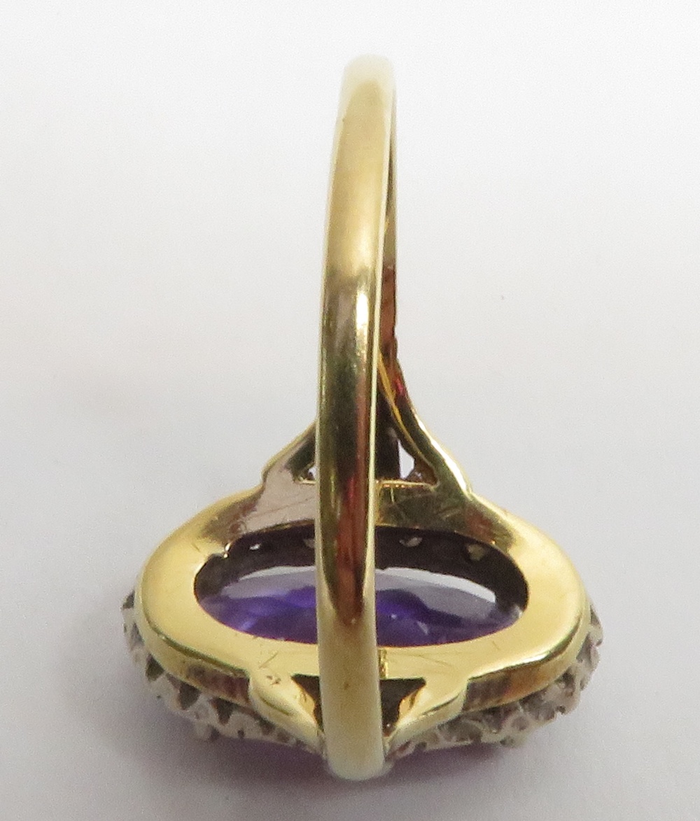 An amethyst and diamond 18 carat gold cluster ring, Birmingham 1975, the long oval cut stone - Image 2 of 3