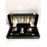 A cased silver three piece cruet set, by Alexander Smith, Birmingham 1962, with spoons and blue