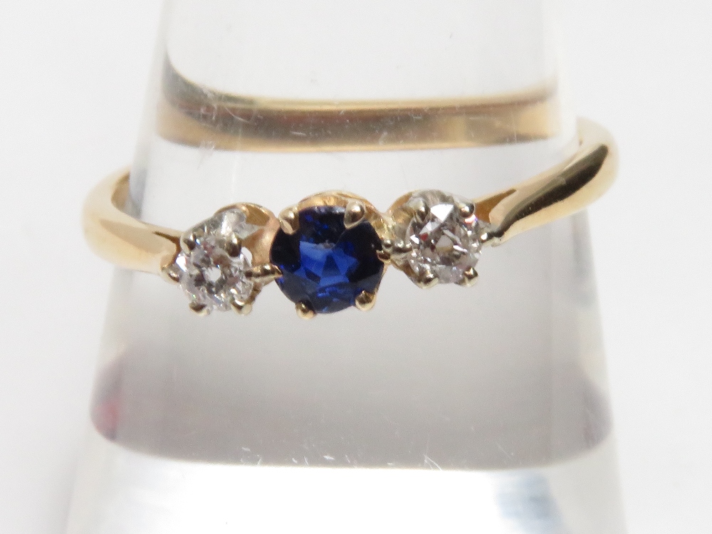 A sapphire and diamond three stone ring, with claw setting, stamped '18ct', size O, 2.3 g gross - Image 2 of 7