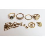 A 9 carat gold wedding ring; three dress rings; a 9 carat gold Saint Christopher pendant; a horse