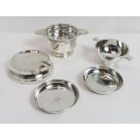 A small silver quaich, by Naylor Brothers, London 1939, of usual form; a silver tea strainer with