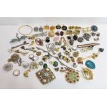 A large collection of costume jewellery, includes some signed pieces; with a plain jade bangle