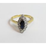 A sapphire and diamond cluster 18 carat gold ring, London 1968, the marquise shaped sapphire