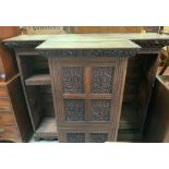 A 19th century oak carved sideboard, flanked by two open bookcase sections, 143cm high, 162cm