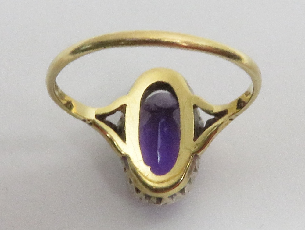 An amethyst and diamond 18 carat gold cluster ring, Birmingham 1975, the long oval cut stone - Image 3 of 3