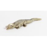 A Japanese ivory netsuke of a crocodile, signed to the base, 12cm long