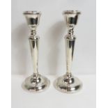 A pair of loaded silver candlesticks, by A. T. Cannon Ltd, Birmingham 1972, 23.5 cm high