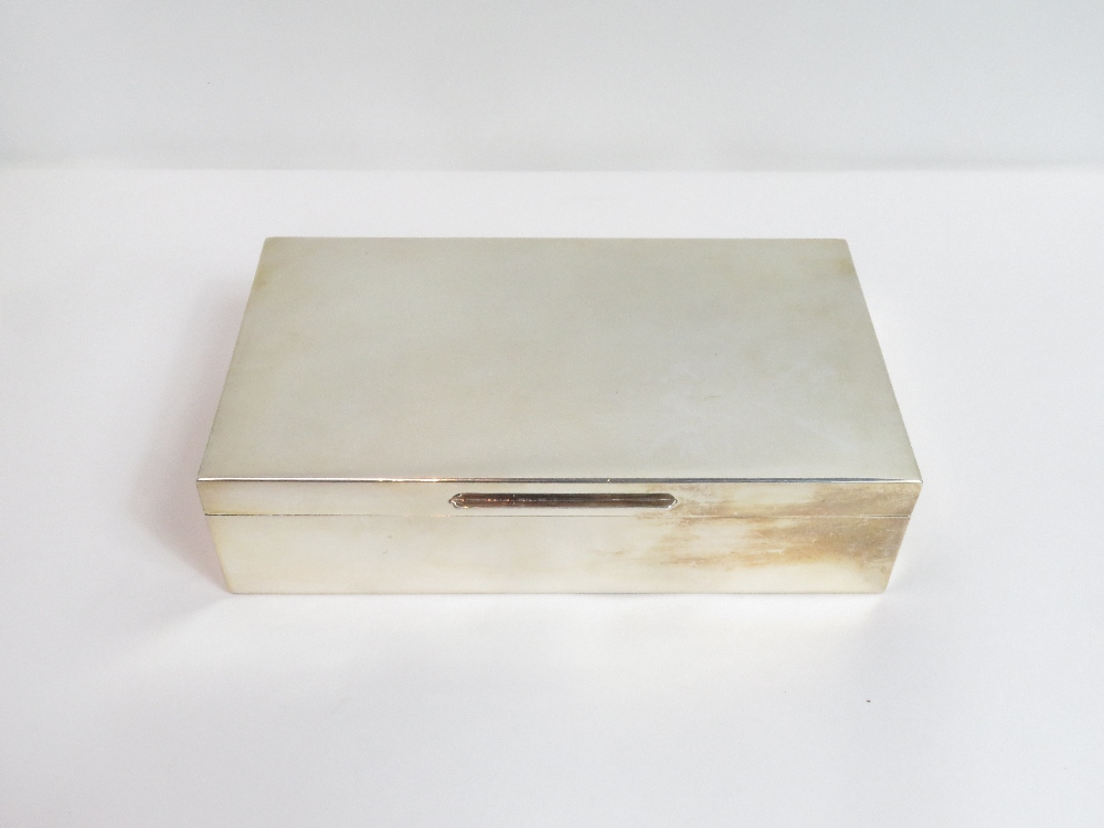 A silver cigarette box, by S. J. Rose, London 1972, of usual plain form 18 cm by 10 cm