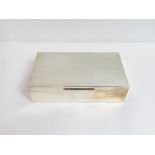 A silver cigarette box, by S. J. Rose, London 1972, of usual plain form 18 cm by 10 cm