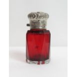 A 19th century ruby glass scent bottle, with an unmarked silver embossed hinged cover, with stopper,