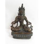 A Tibetan bronze statue of a buddha, 23cm high