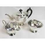 A silver three piece tea service, by E. Viner, Sheffield 1930, of panelled form on a spreading foot;