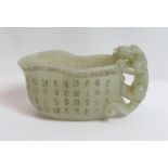 WITHDRAWN A Chinese Jade libation cup, the handle in the form of a lion, with various