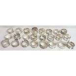 A collection of twenty one silver napkin rings, various dates and makers, 285 g (9.1 troy ozs)