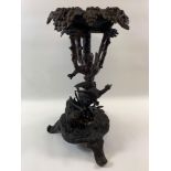 A Victorian Black Forest torchere modelled as a tree with foliage and branches to the top and the