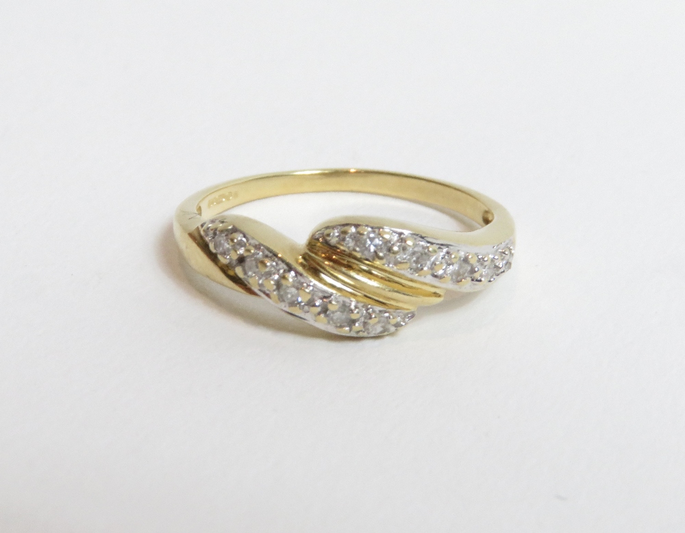 A diamond set 14 carat gold QVC ring, set with fourteen single cut diamonds to a cross over
