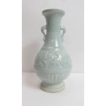 A Chinese celadon vase, decorated with a stylised running flower centre, raised on circular base,