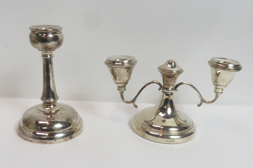 A loaded silver two light short candelabra, Birmingham 1963, 9 cm high; with a single loaded