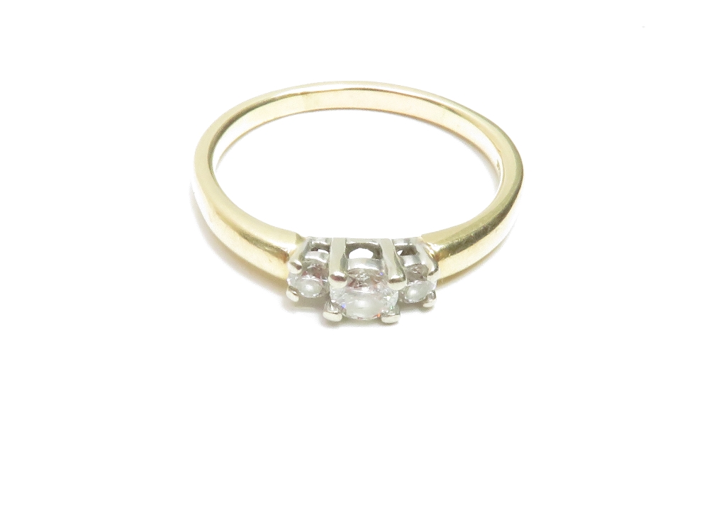 A 14k three stone diamond ring, the central stone flanked by smaller stones - Image 2 of 5