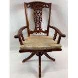 A modern Oriental hardwood desk swivel chair with decorative splat back, curved arms, solid seat
