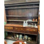 A 19th century oak dresser, with three central short drawers, 216cm high, 190cm long, 42cm deep