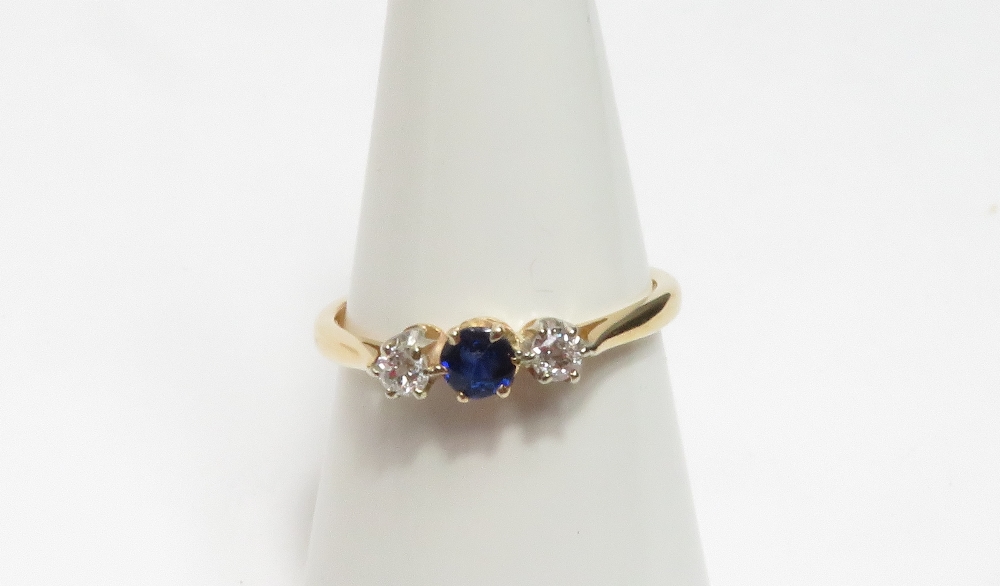 A sapphire and diamond three stone ring, with claw setting, stamped '18ct', size O, 2.3 g gross