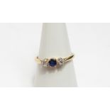 A sapphire and diamond three stone ring, with claw setting, stamped '18ct', size O, 2.3 g gross