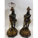 A fine pair of Victorian ormulu and bronze figural oil lamps, each circular facet cut bowl