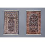 Two Oriental prayer rugs with floral design, silk on cotton, 20th C.