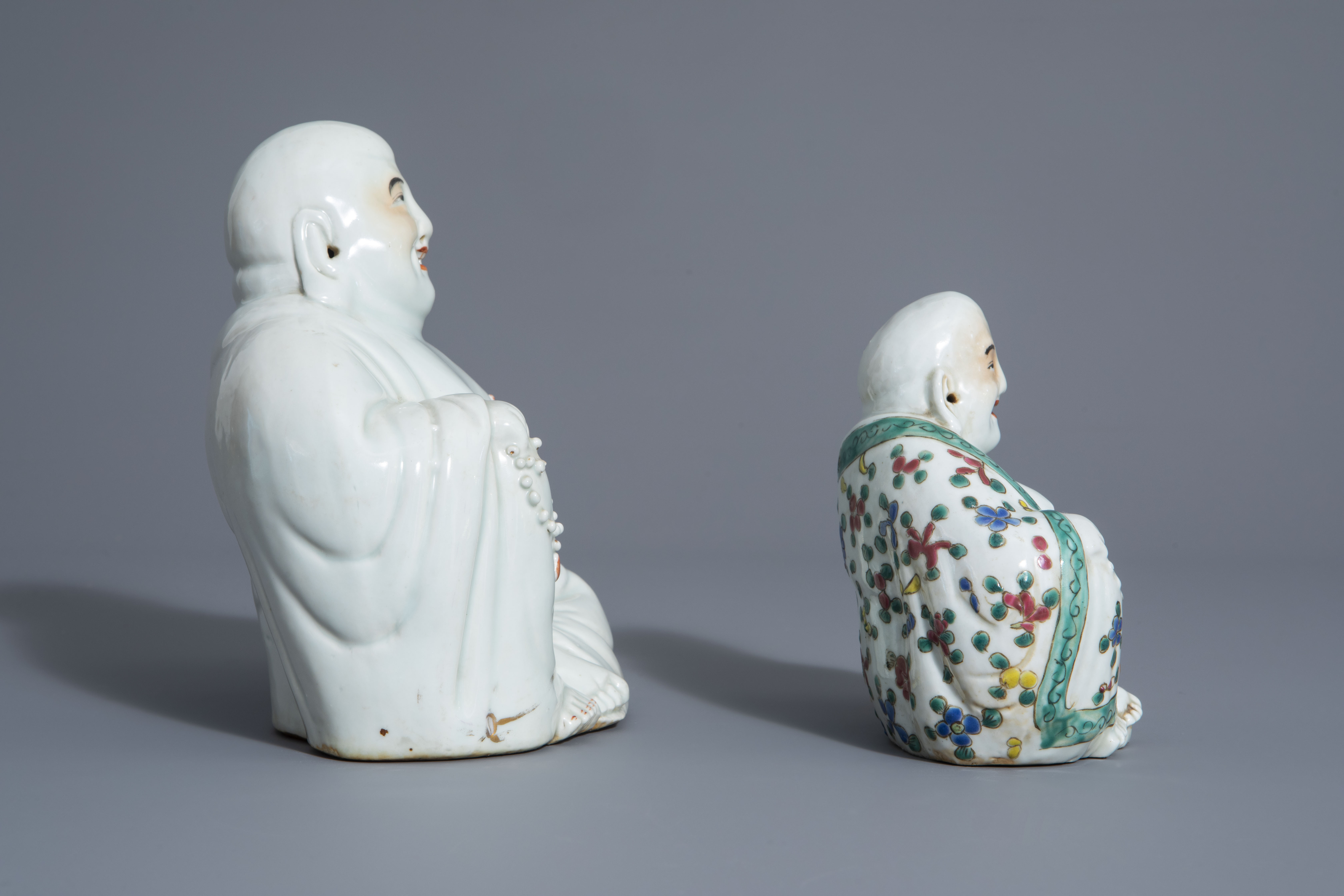Two Chinese white, iron red, gilt and famille rose porcelain figures of Buddha, 19th/20th C. - Image 3 of 7