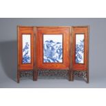 A Chinese threefold wooden screen with blue and white plaques, 19th/20th C.