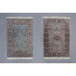 Two Oriental rugs with floral design, silk on cotton, 20th C.