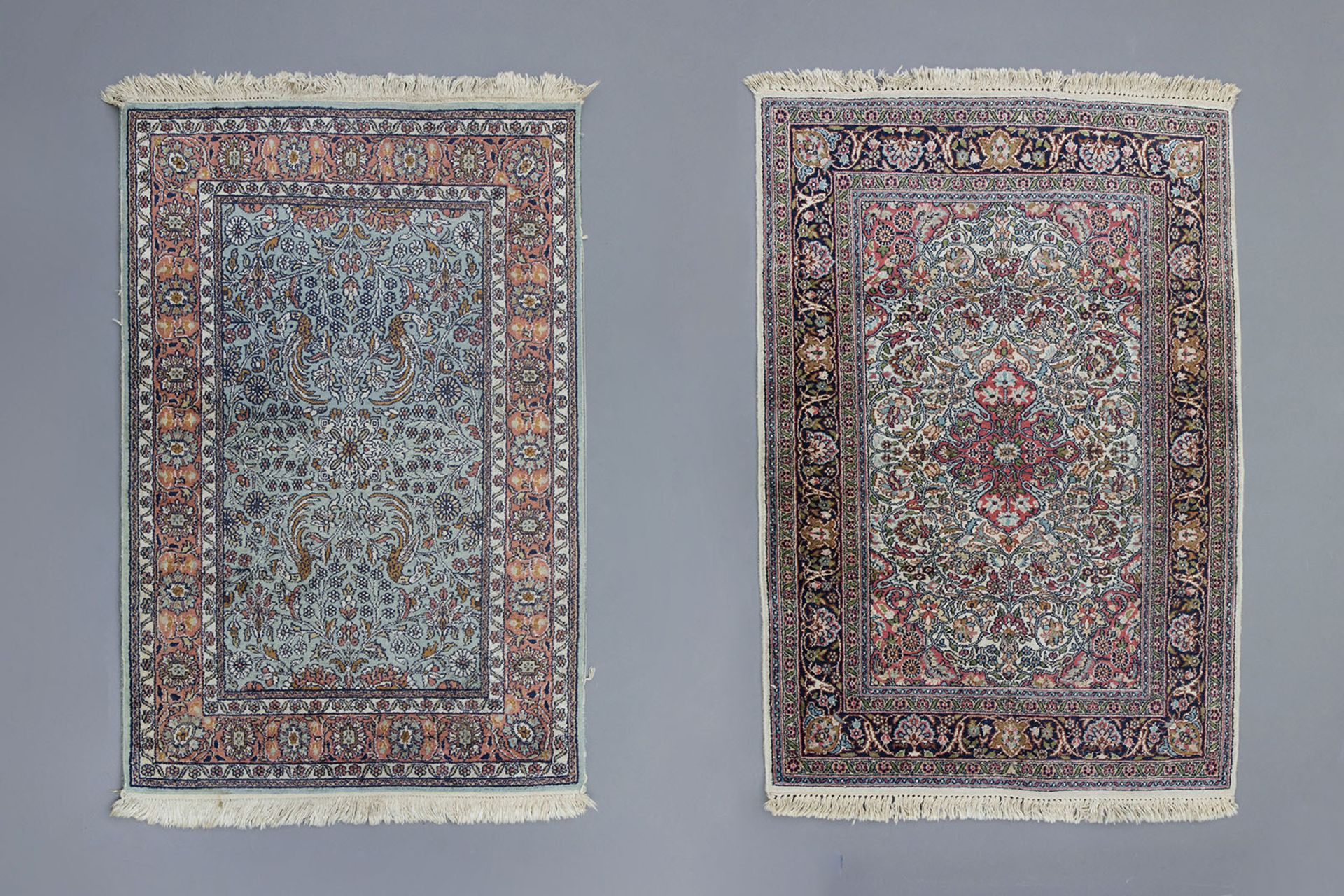 Two Oriental rugs with floral design, silk on cotton, 20th C.