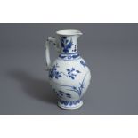 A Chinese blue and white jug with floral design, Transition, 17th C.