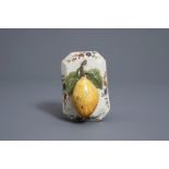 A polychrome Dutch Delft model of a lemon on a base, about 1800