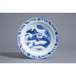 A Chinese blue and white dish with figures in a landscape, Wanli