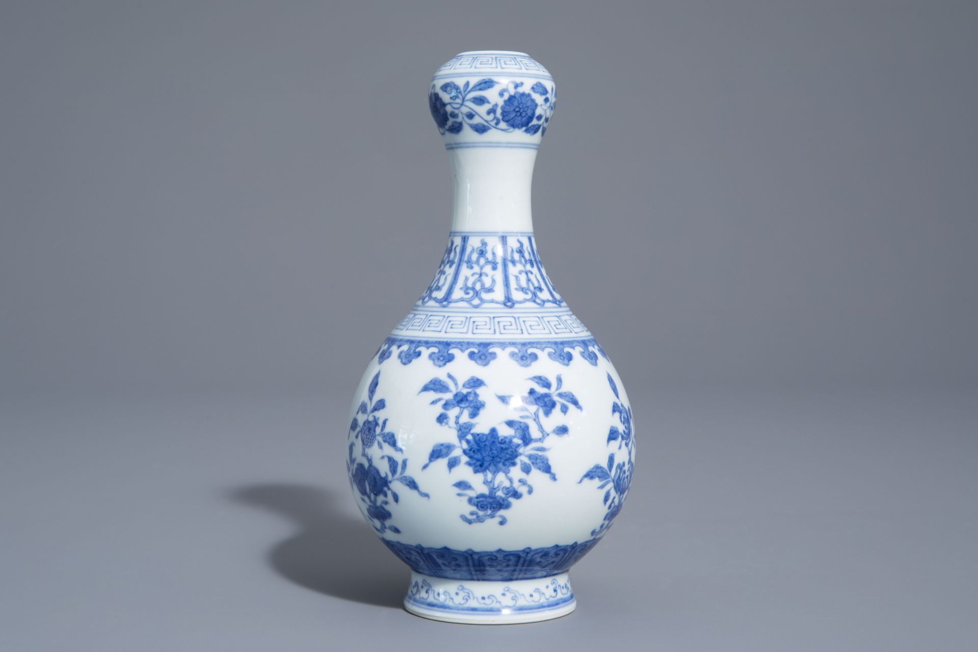 A Chinese blue and white garlic-head mouth vase with floral design, Qianlong mark, 20th C. - Image 2 of 7