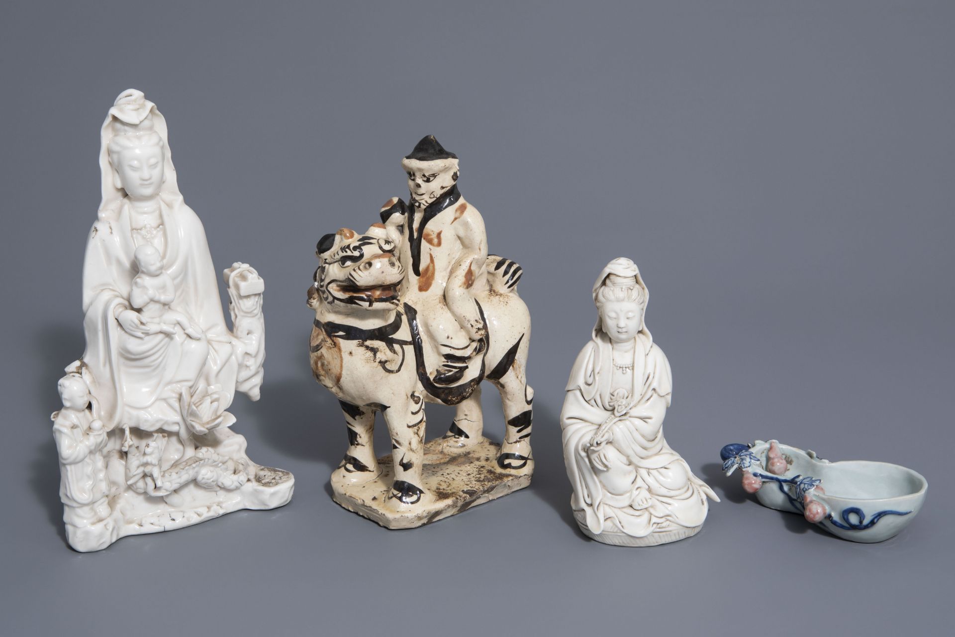 A Chinese blue, white & red brushwasher, a Cizhou figure & two blanc de Chine Guanyin, Ming & later