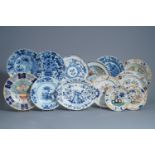 Twelve polychrome and blue and white Dutch Delft plates and an oval tray, 18th C.