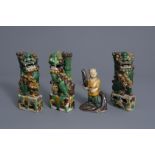 Three Chinese famille verte biscuit models: Buddhist lions and a figure of a boy, Kangxi & later