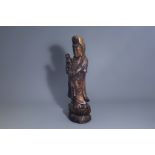 A large Chinese patinated wooden figure of Guanyin and child on a lotus throne, Qing