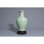 A Chinese monochrome celadon crackle glazed vase on stand, 19th/20th C.