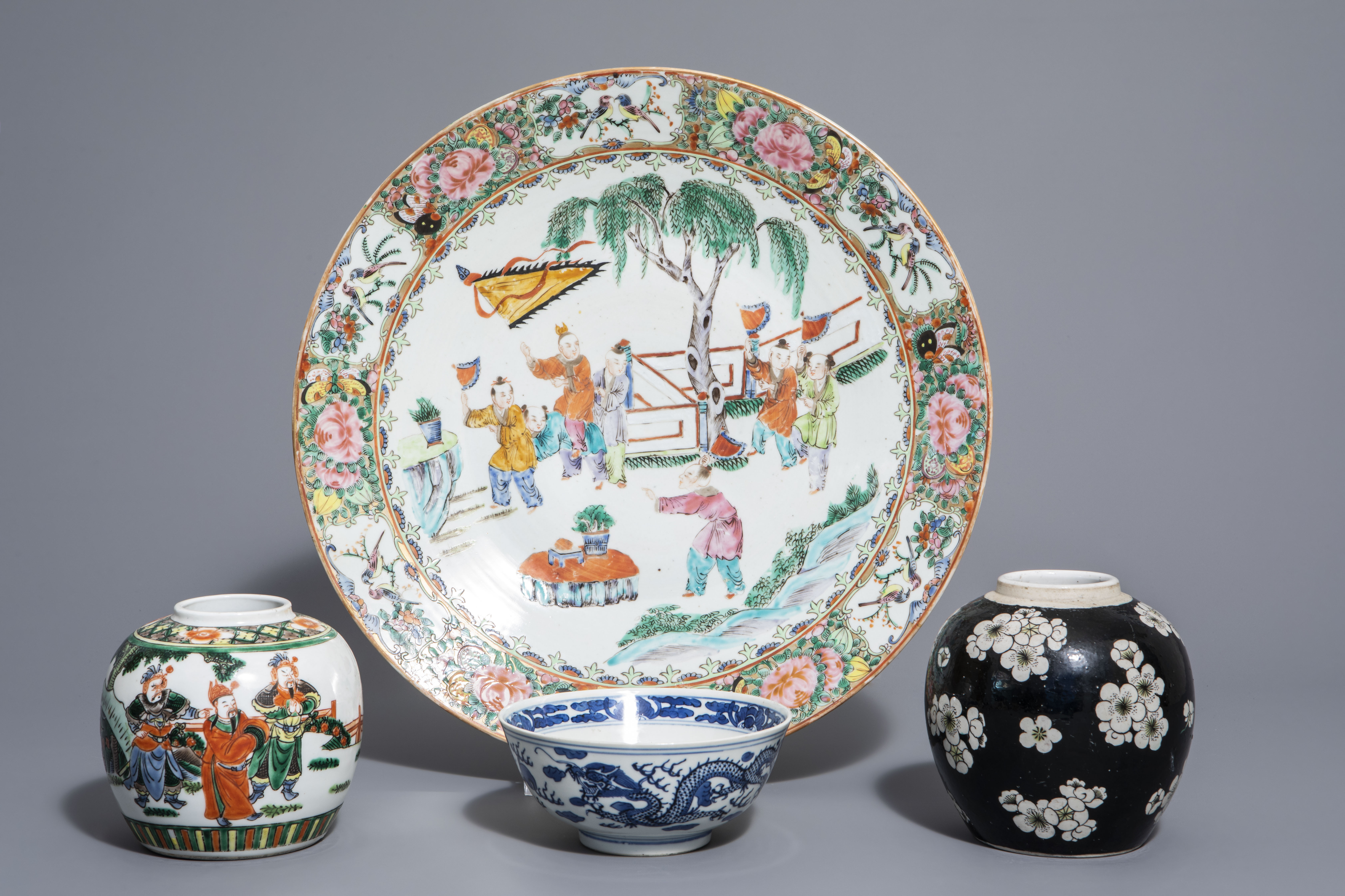 A Chinese Canton famille rose charger and two vases and a bowl with different designs, 19th C.