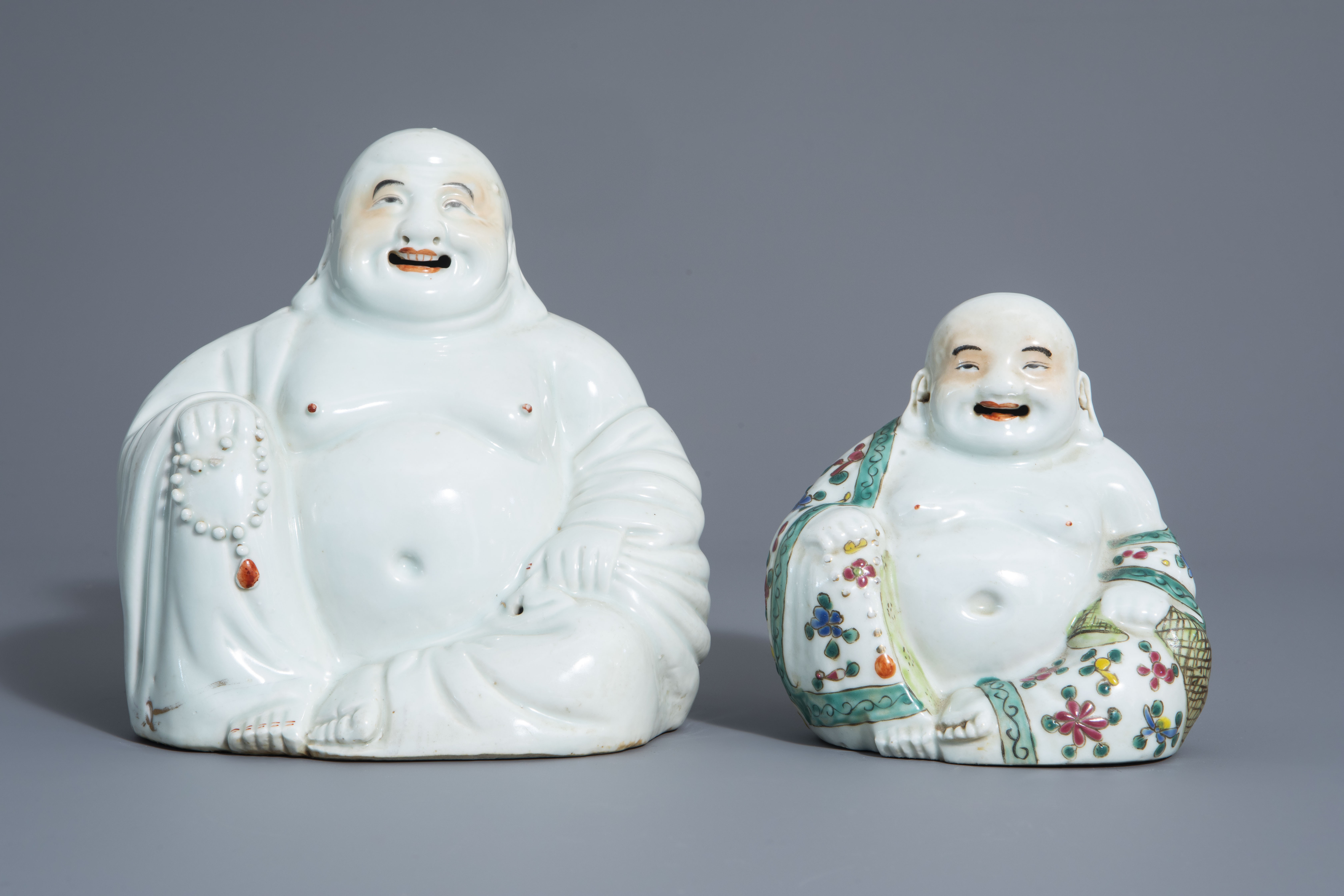 Two Chinese white, iron red, gilt and famille rose porcelain figures of Buddha, 19th/20th C. - Image 2 of 7