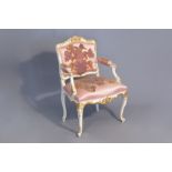 A probably South German parcel gilt and white painted Louis XV armchair, 18th C.