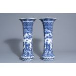 A pair of octagonal Japanese blue and white vases with figures in a landscape, Meiji/Showa, 20th C.